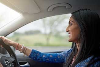 A group of students receiving instruction from a driving instructor at Arohi Driving School.