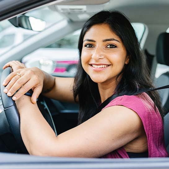 Image of students celebrating passing their driving test.